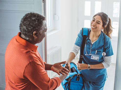 Home health nurse shaking hands with a patient